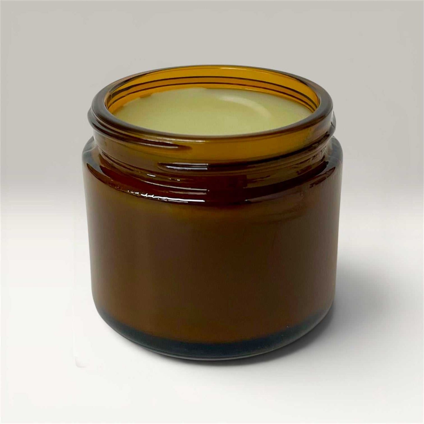 Herbal Healing Salve in amber jar with calendula and comfrey ingredients for natural skin soothing and healing