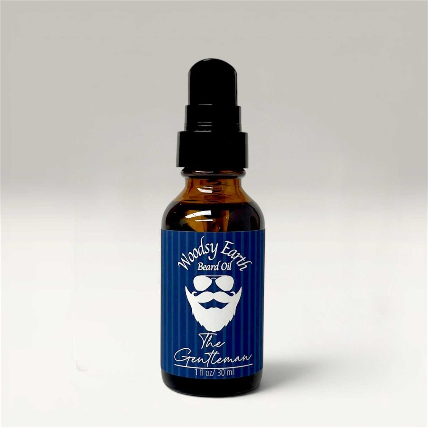 Bottle of premium beard oil with natural botanical ingredients on wooden background