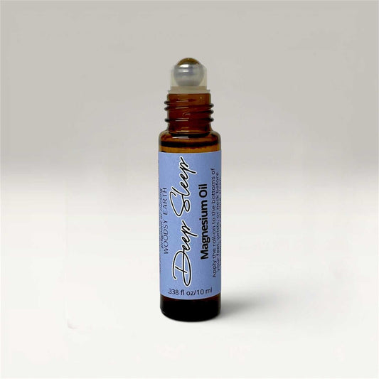 Three 10ml Magnesium Oil Roll-On bottles labeled Calm Mind, Deep Sleep, and Breathe Easy on a wooden surface