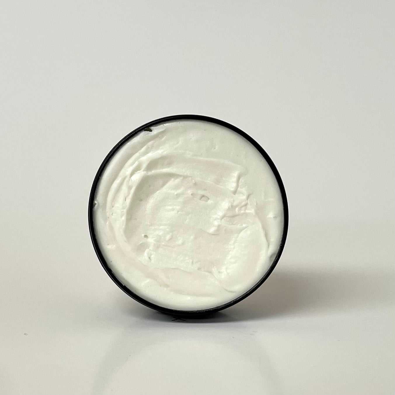 Magnesium Tallow Butter in a compact travel tin with herbal-infused moisturizing formula