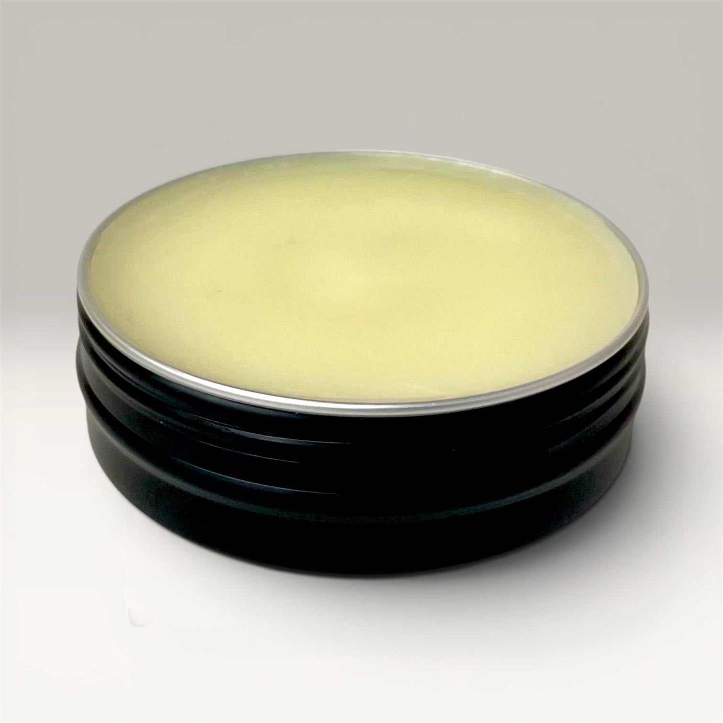 Handcrafted beard balm tin with nourishing ingredients for medium hold and moisture