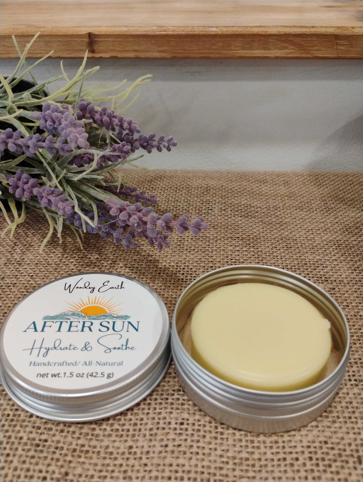 After Sun lotion bar in metal tin with lavender sprig, handcrafted with grass-fed tallow, calendula, comfrey, peppermint, and lavender to hydrate and soothe sunburn.