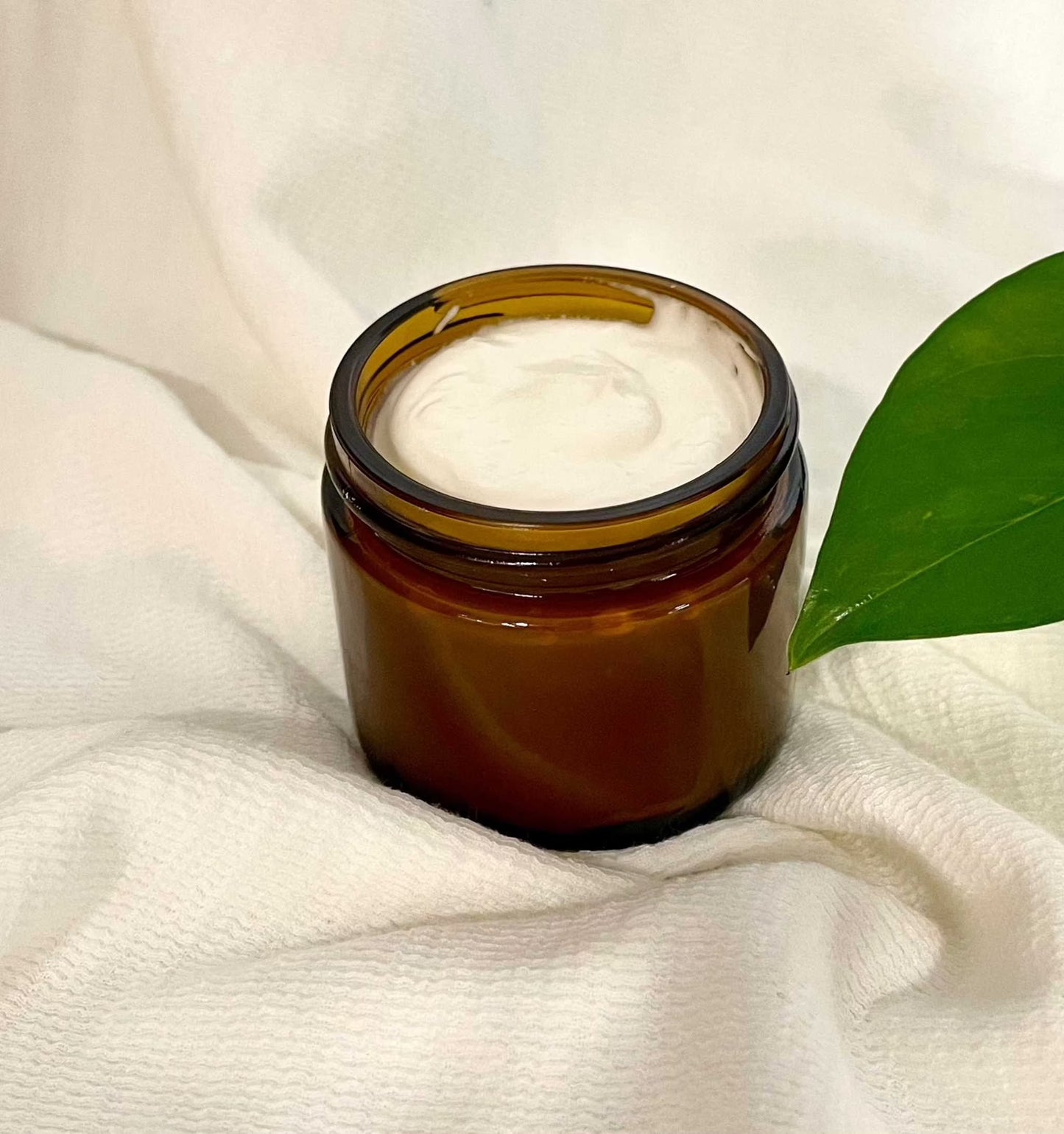 Woodsy Earth Sweet Renewal Pregnancy Cream in amber jar with nourishing natural ingredients for expecting moms, soothing and hydrating skin