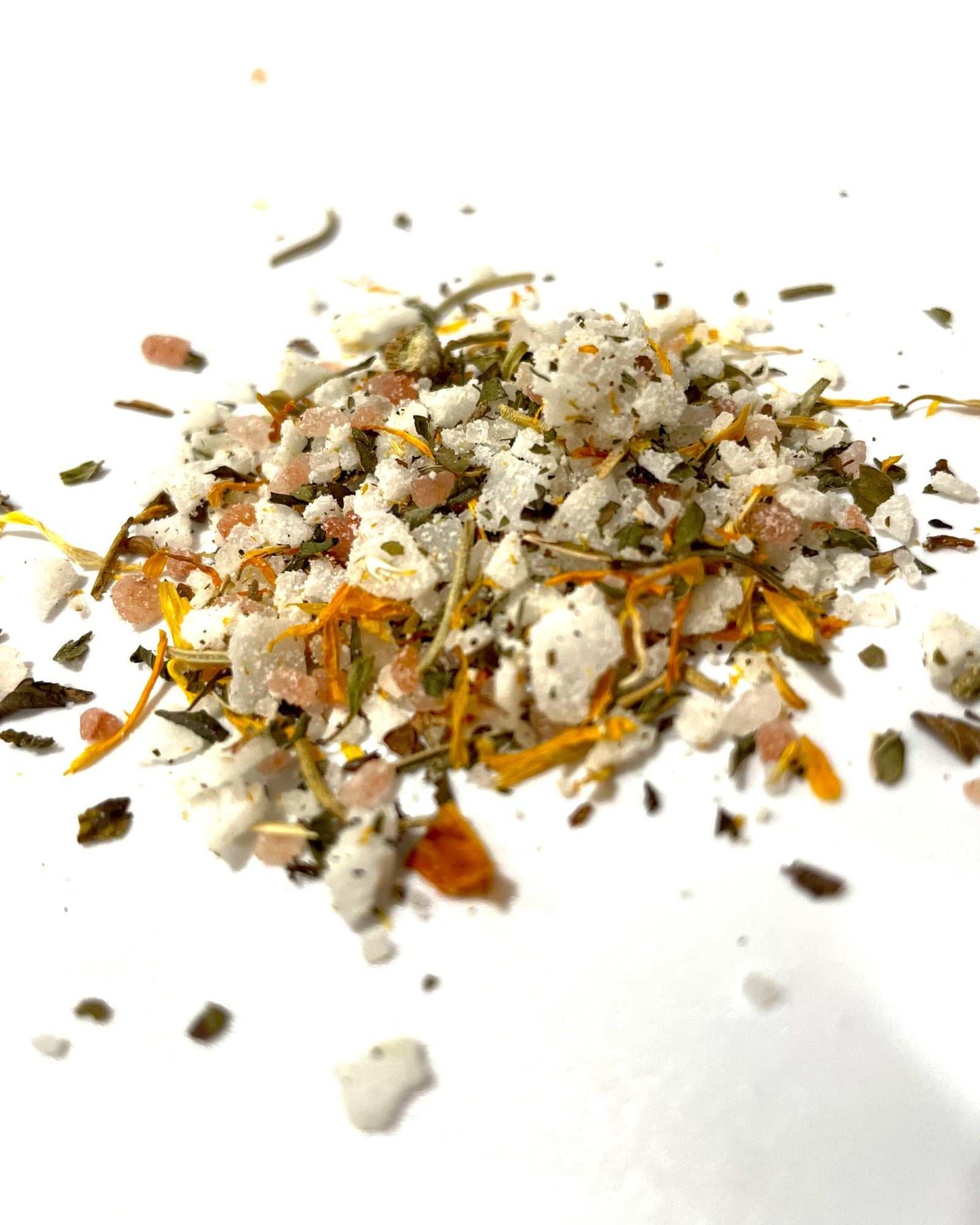 Loose herbal magnesium bath soak with Dead Sea salt, Himalayan salt, and botanicals for detox and relaxation on white background.