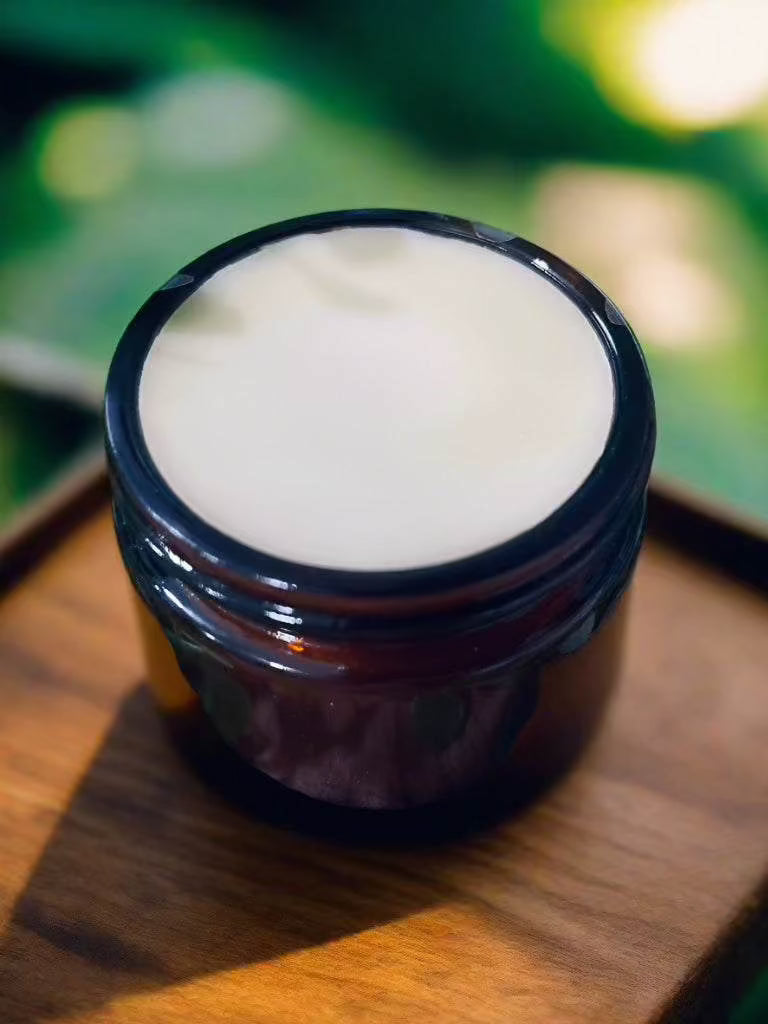Open amber glass jar of Woodsy Earth Herbal Healing Salve for soothing and nourishing skin