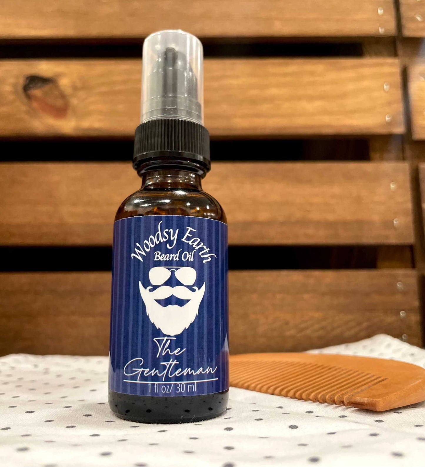 Woodsy Earth The Gentleman Beard Oil with cedarwood, vetiver, and vanilla oils in a 1 oz (30 ml) bottle for softening and moisturizing beards.