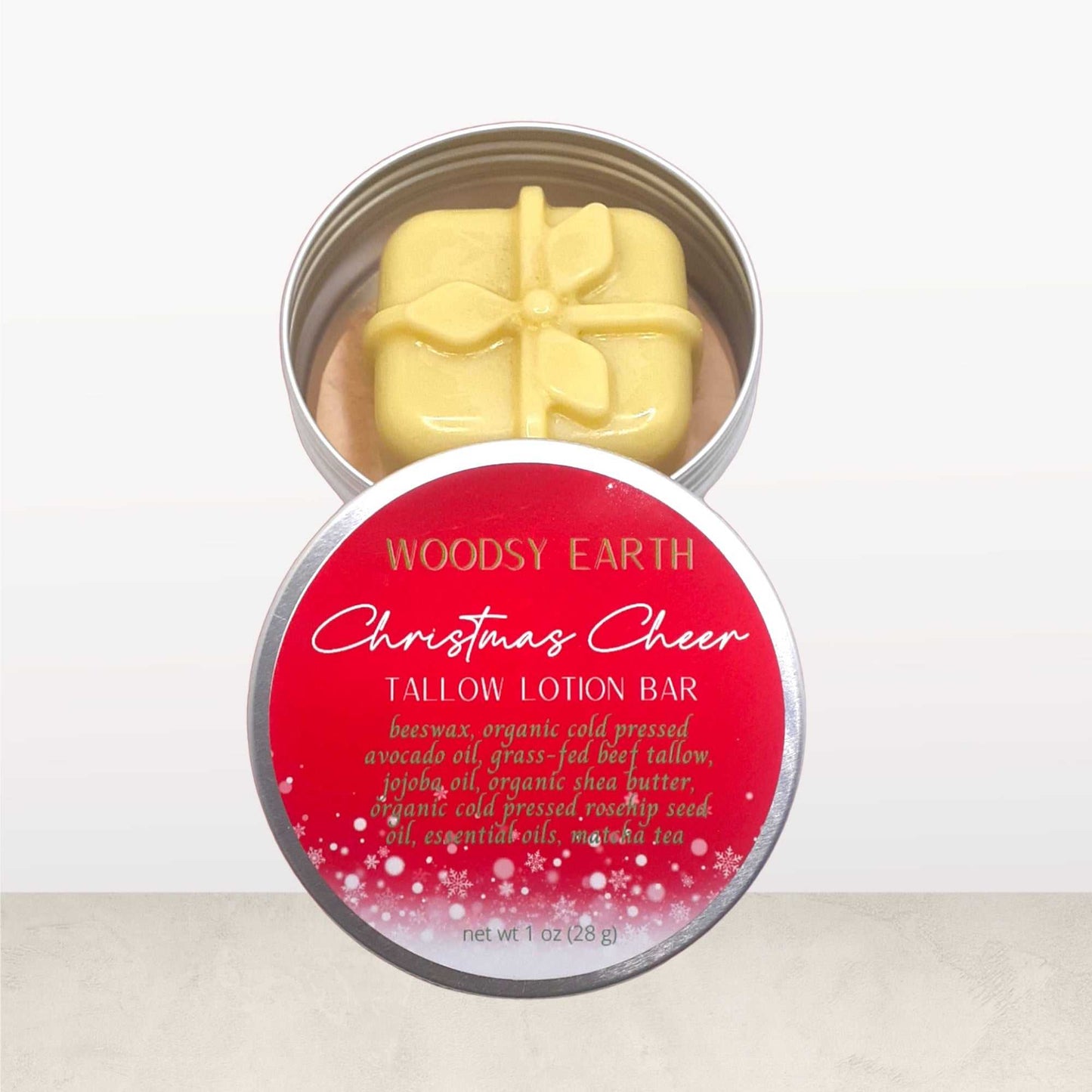 Christmas Cheer Tallow Lotion Bar in festive tin with gift-shaped lotion bar, made with grass-fed tallow, shea butter, avocado oil, and essential oils for holiday skincare.