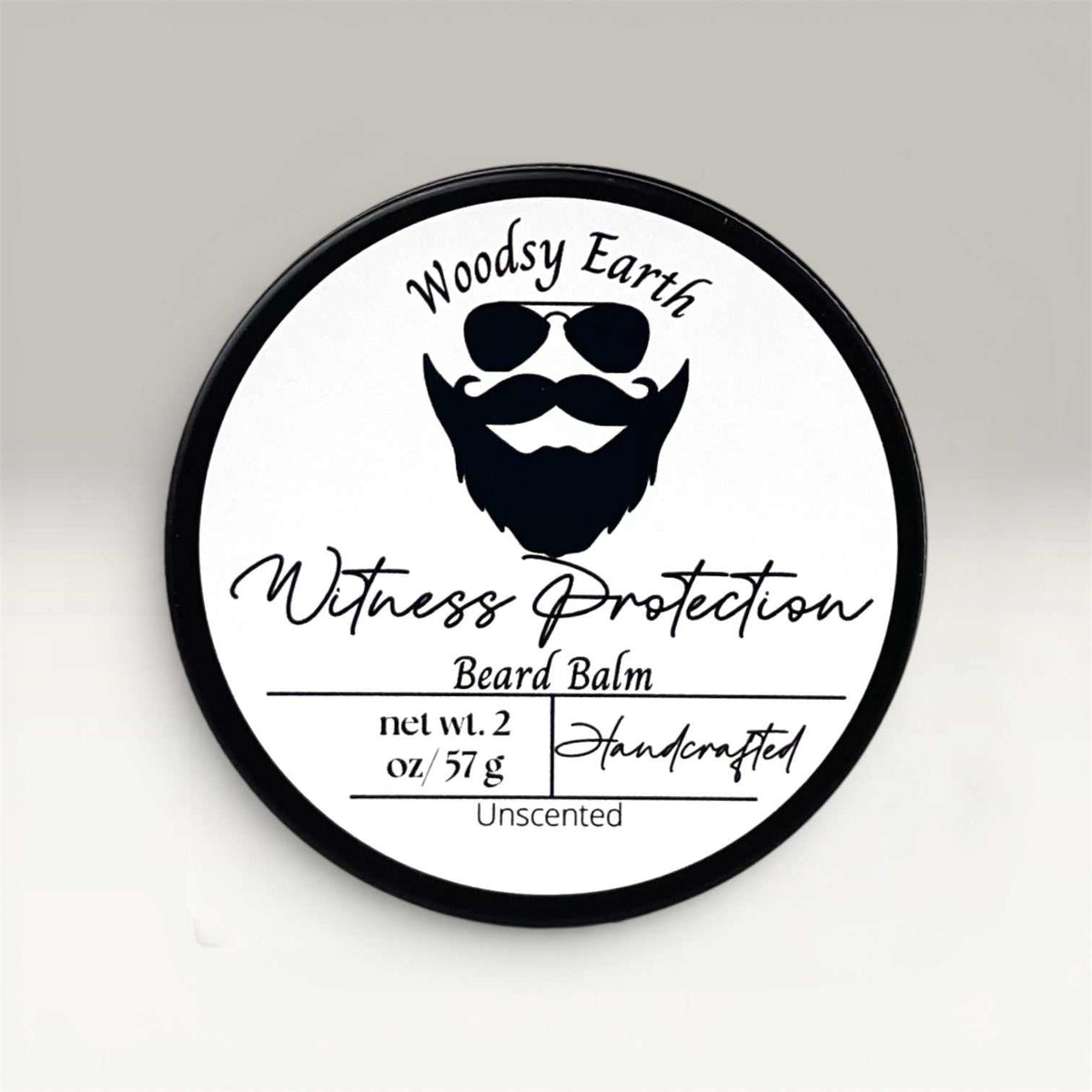 2oz tin of handcrafted beard balm with nourishing ingredients and medium hold for refined grooming