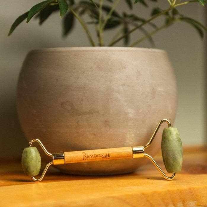 Bamboo Switch bamboo facial massage roller with rose quartz stones, ideal for skin care and relaxation.