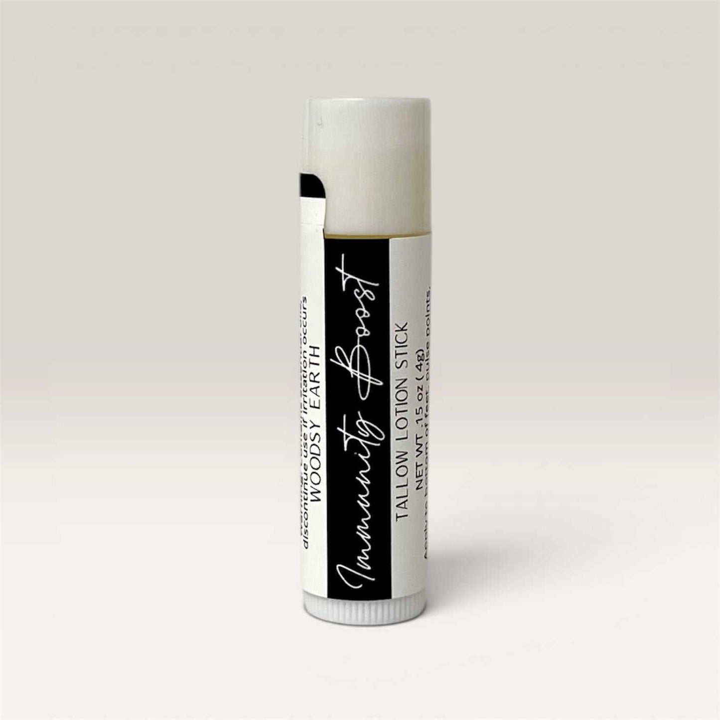 Immunity Boost Tallow Lotion Stick solid bar with natural ingredients and woodsy scent for skin nourishment and wellness.