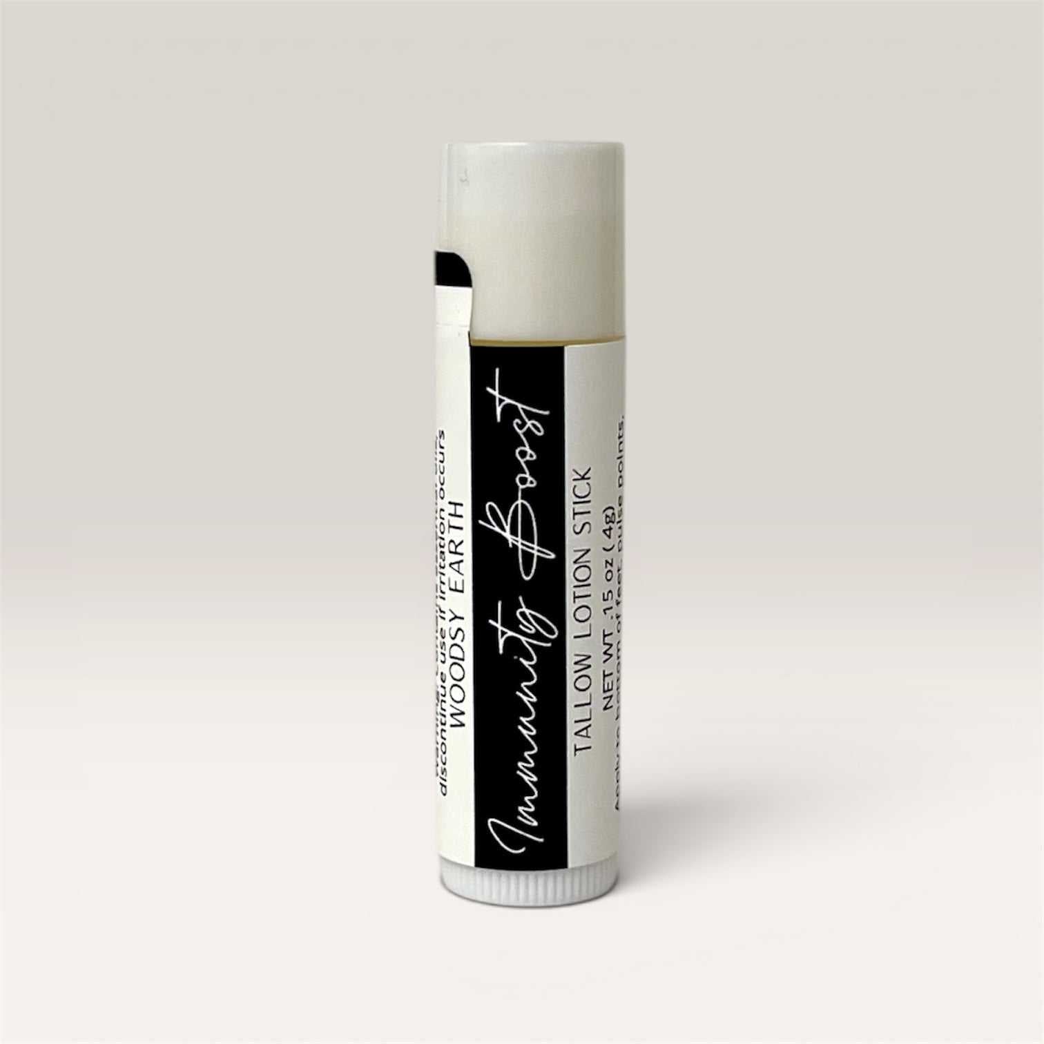 Immunity Boost Tallow Lotion Stick solid bar with natural ingredients and woodsy scent for skin nourishment and wellness.