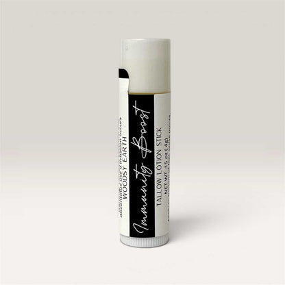 Immunity Boost Tallow Lotion Stick solid bar with natural ingredients and woodsy scent for skin nourishment and wellness.