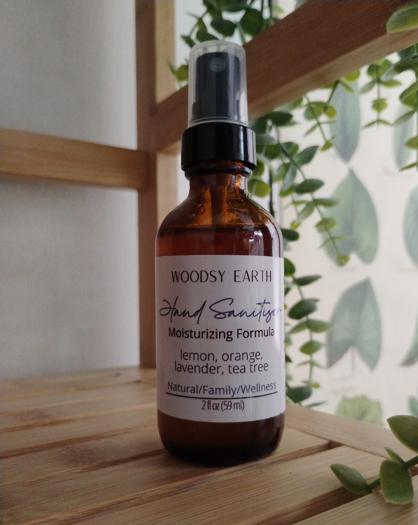 Moisturizing hand sanitizer with natural ingredients in amber glass spray bottle.