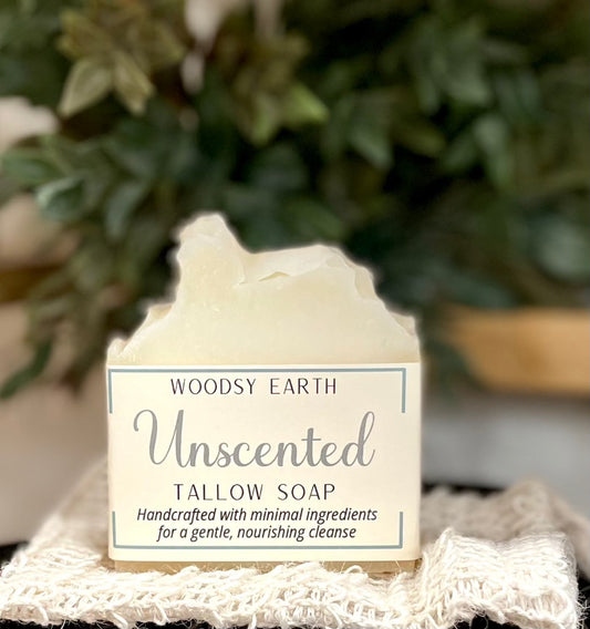 Pure & Simple Unscented Tallow Soap bar on a textured cloth with greenery in the background.