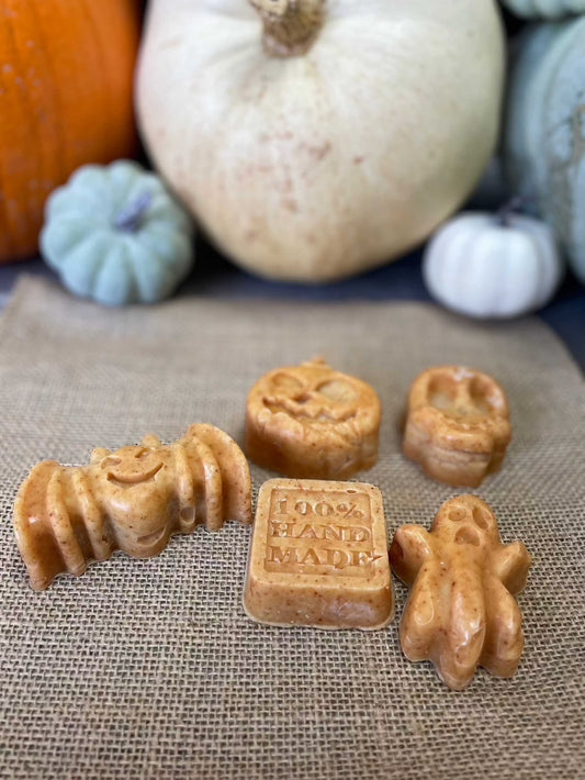 Haunted Harvest Tallow Soap in festive fall shapes with turmeric color, surrounded by pumpkins.