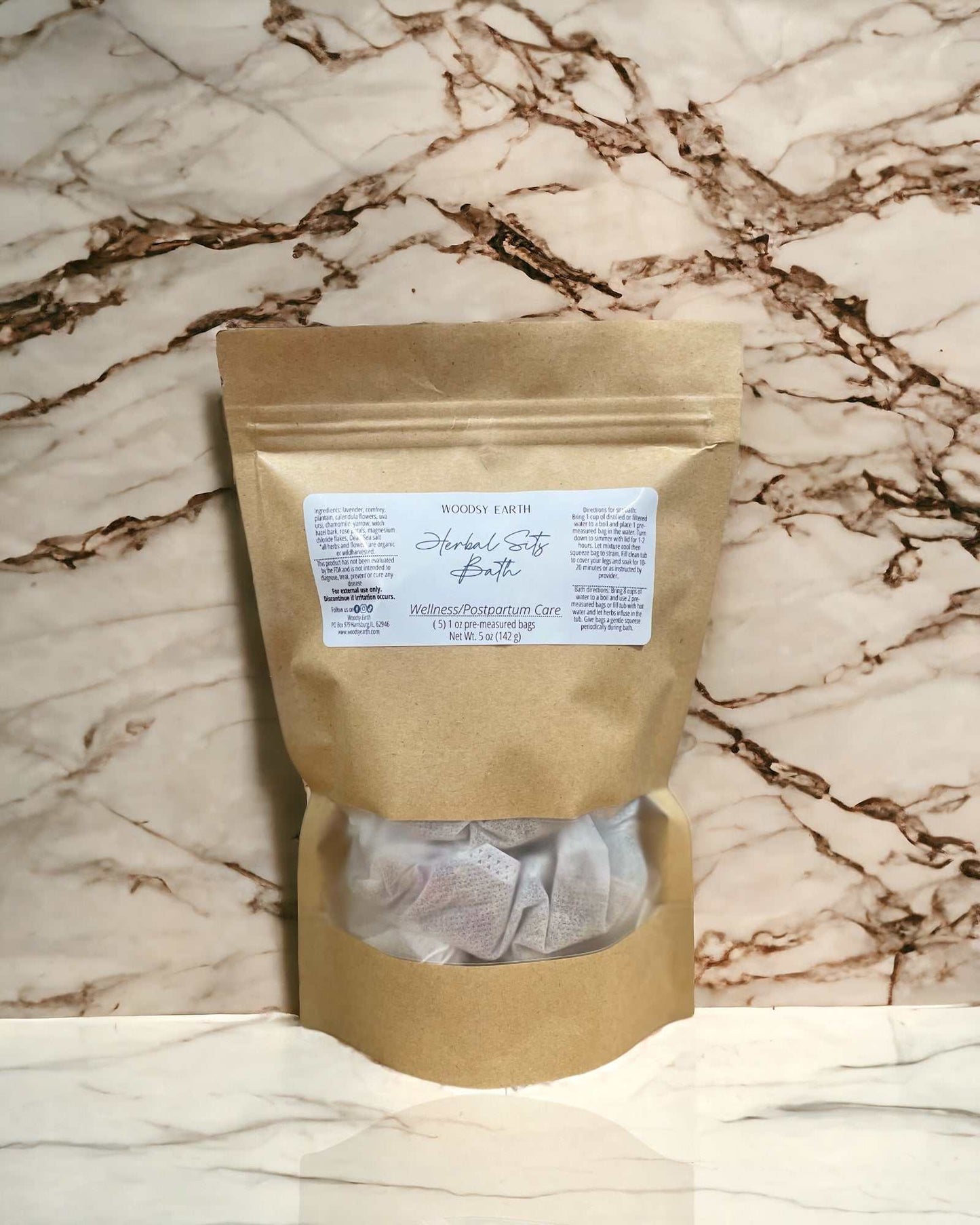 Postpartum Herbal Sitz Bath package on marble background, featuring natural ingredients for healing.