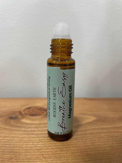 Magnesium Oil Roll-On bottle on wooden surface.