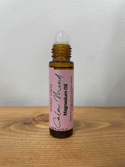 Magnesium Oil Roll-On for Calm Mind on wooden surface.