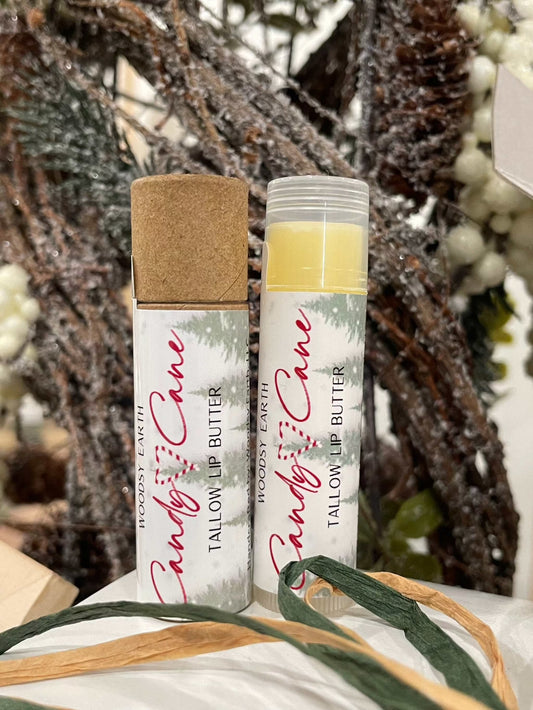 Candy Cane Tallow Lip Butter with peppermint, spearmint, and vanilla essential oils. Two tubes shown, one with cap on and one open, nourishing natural lip care