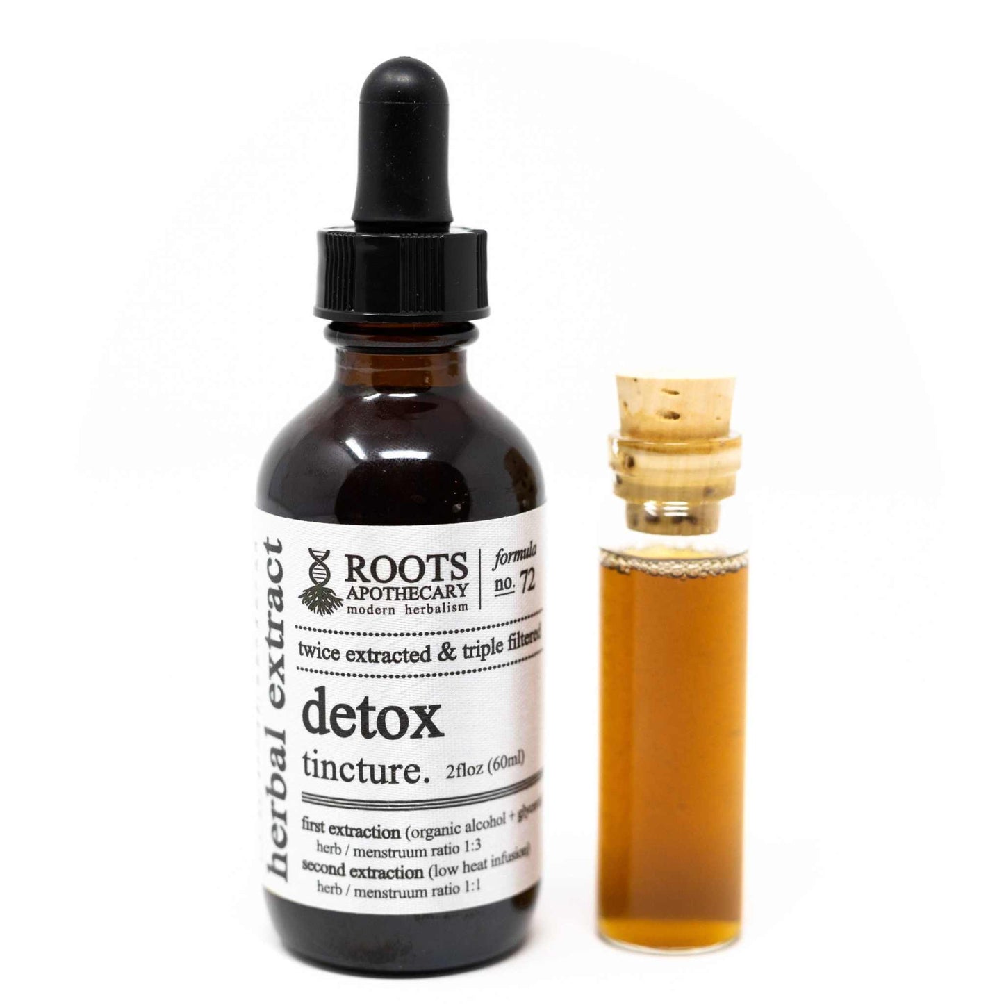 Roots Apothecary Detox tincture in a dark glass dropper bottle with small corked vial of amber herbal extract