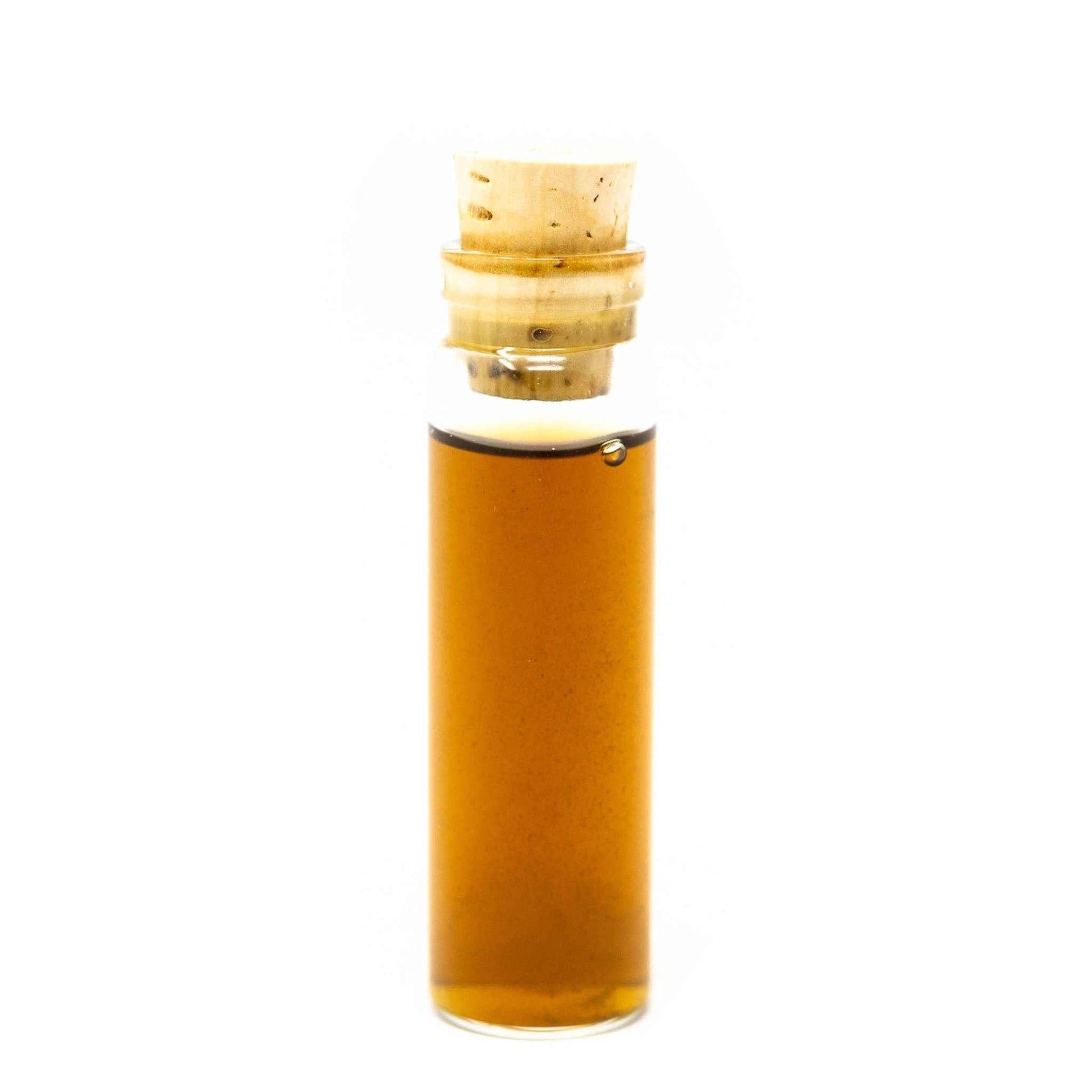 Roots Apothecary herbal tincture in a small glass sample bottle with cork stopper containing amber liquid
