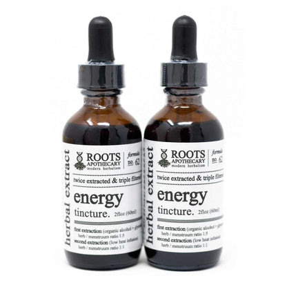 Roots Apothecary Energy Tincture with twice extracted energy blend in glass bottles.