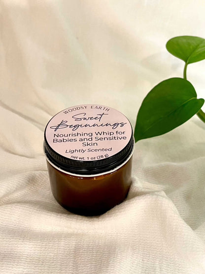 Woodsy Earth Sweet Beginnings Baby Cream in amber jar, nourishing whip for babies and sensitive skin, lightly scented natural moisturizer