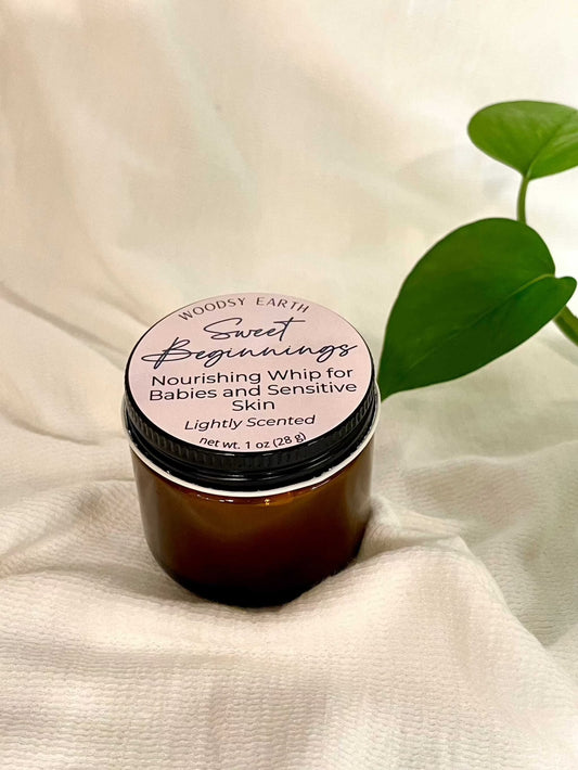 Woodsy Earth Sweet Beginnings Baby Cream in amber jar, nourishing whip for babies and sensitive skin, lightly scented natural moisturizer