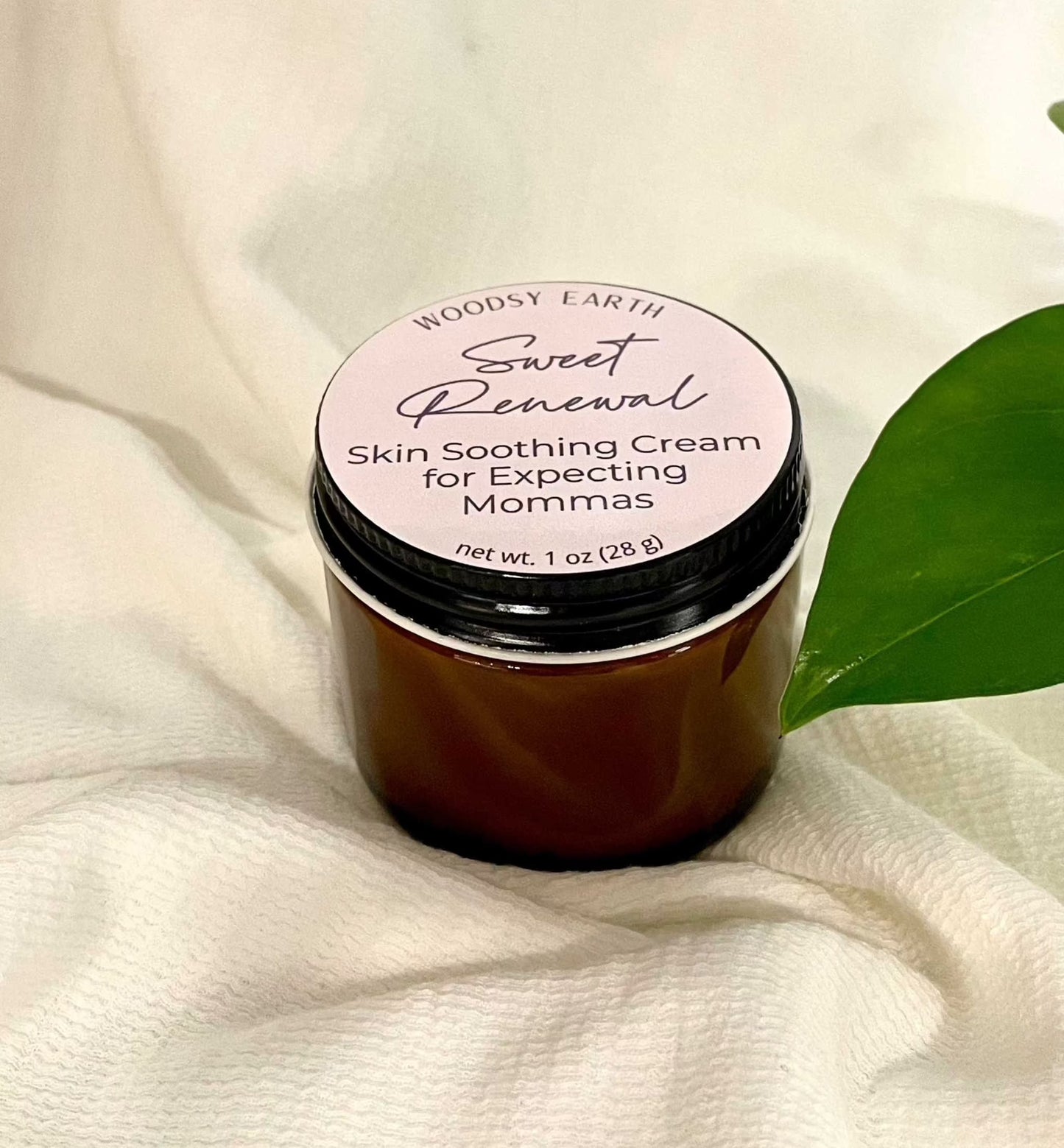 Woodsy Earth Sweet Renewal Skin Soothing Cream for Expecting Moms in amber jar with natural green leaf, gentle pregnancy-safe skincare