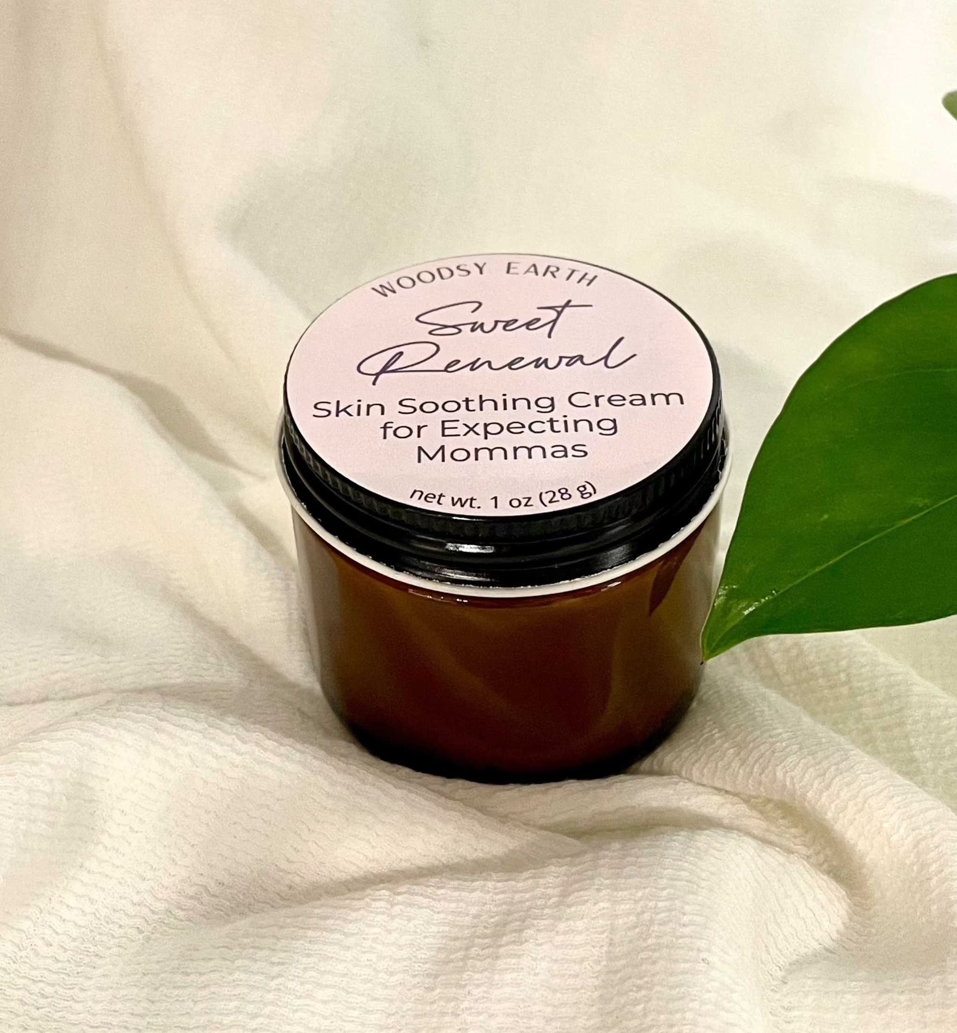 Woodsy Earth Sweet Renewal Skin Soothing Cream for Expecting Moms in amber jar with natural green leaf, gentle pregnancy-safe skincare
