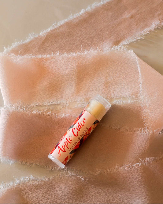 Woodsy Earth Apple Cider Tallow Lip Butter in a tube, natural moisturizing balm made with grass-fed tallow for soft, nourished lips.