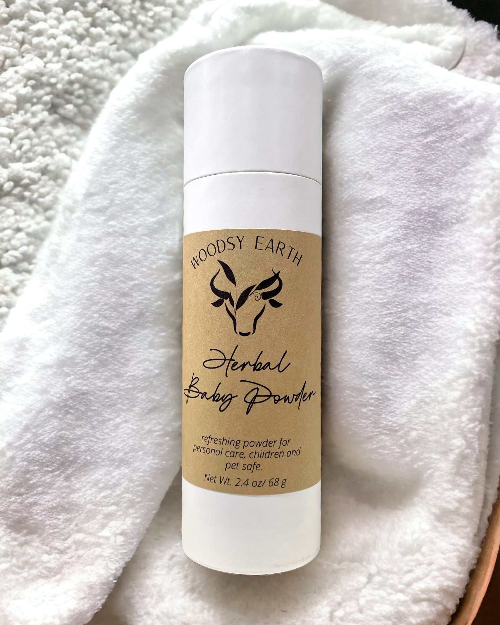 Woodsy Earth Herbal Baby Powder in eco-friendly paper packaging, natural talc-free powder for babies, kids, and adults.