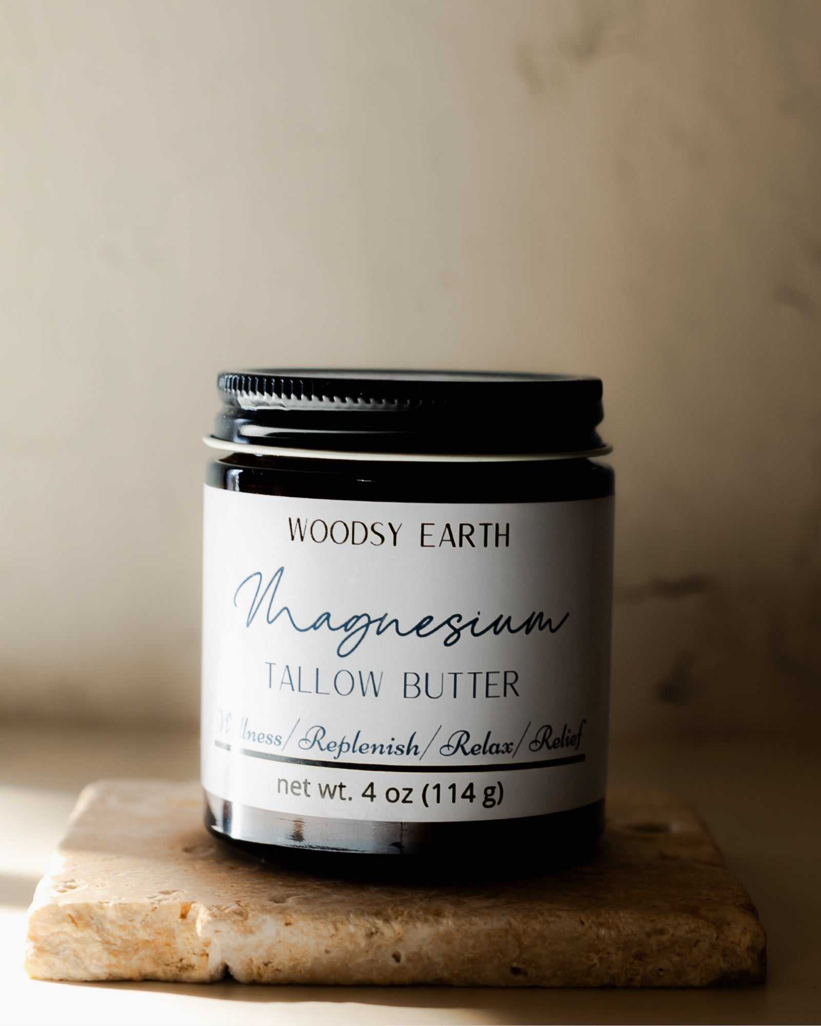 Woodsy Earth Magnesium Tallow Body Butter infused with St. John’s Wort and rosemary in a 4 oz amber jar, natural pain and muscle relief skincare.
