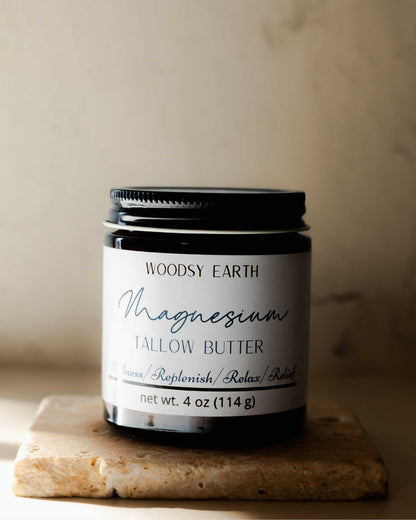 Woodsy Earth Magnesium Tallow Body Butter infused with St. John’s Wort and rosemary in a 4 oz amber jar, natural pain and muscle relief skincare.