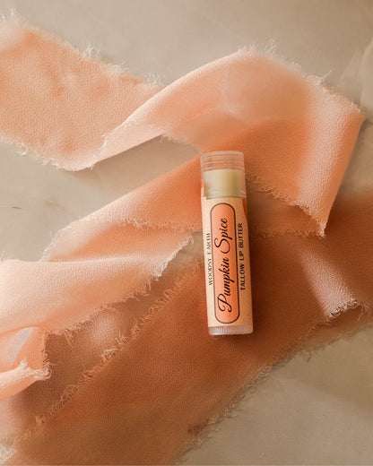Woodsy Earth Pumpkin Spice Latte Tallow Lip Butter in tube, nourishing natural lip balm made with grass-fed tallow for soft, moisturized lips