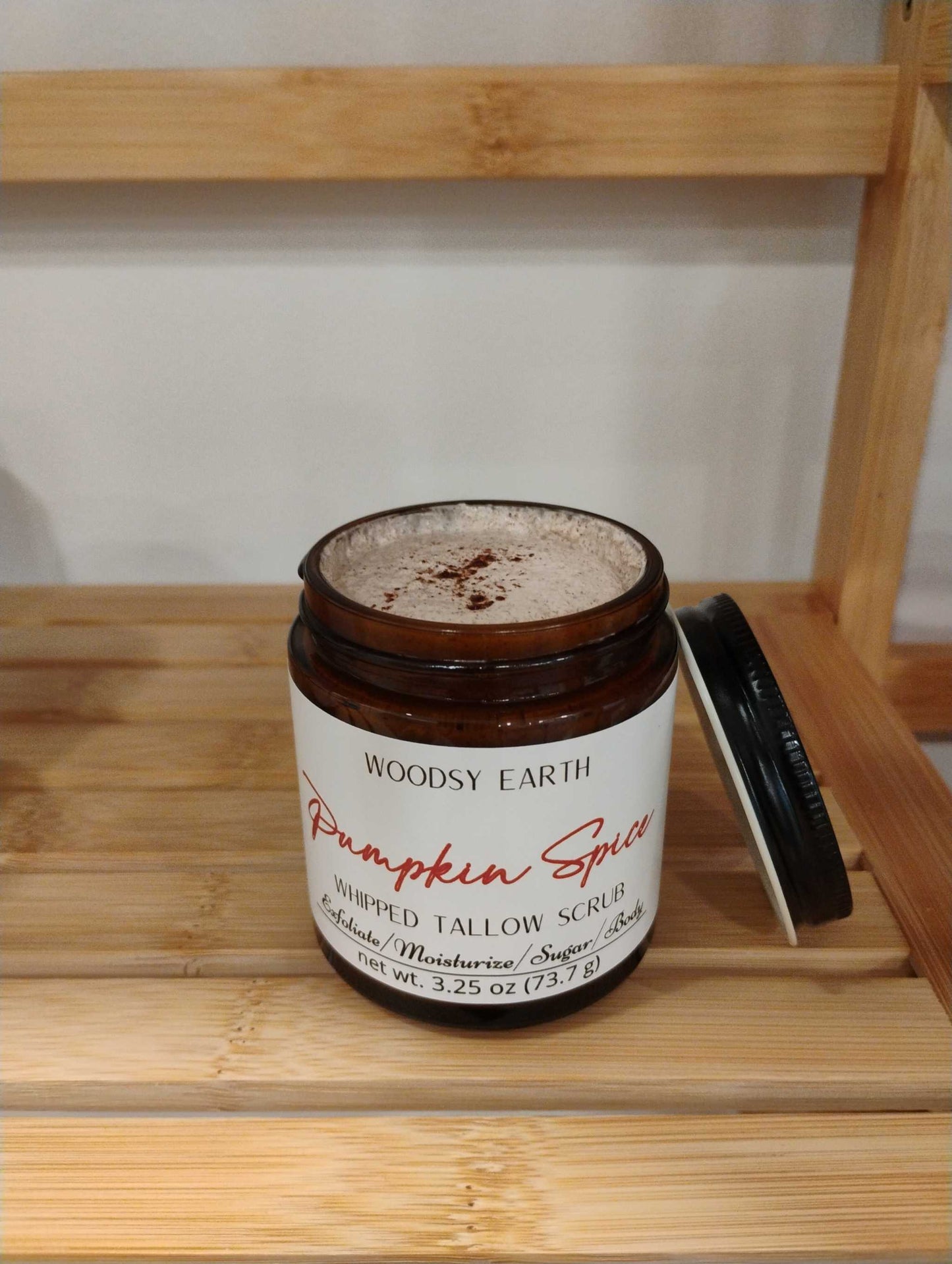 Pumpkin Spice Tallow Sugar Scrub in brown jar with black lid, natural exfoliant with raw sugar cane and avocado oil on wooden shelf