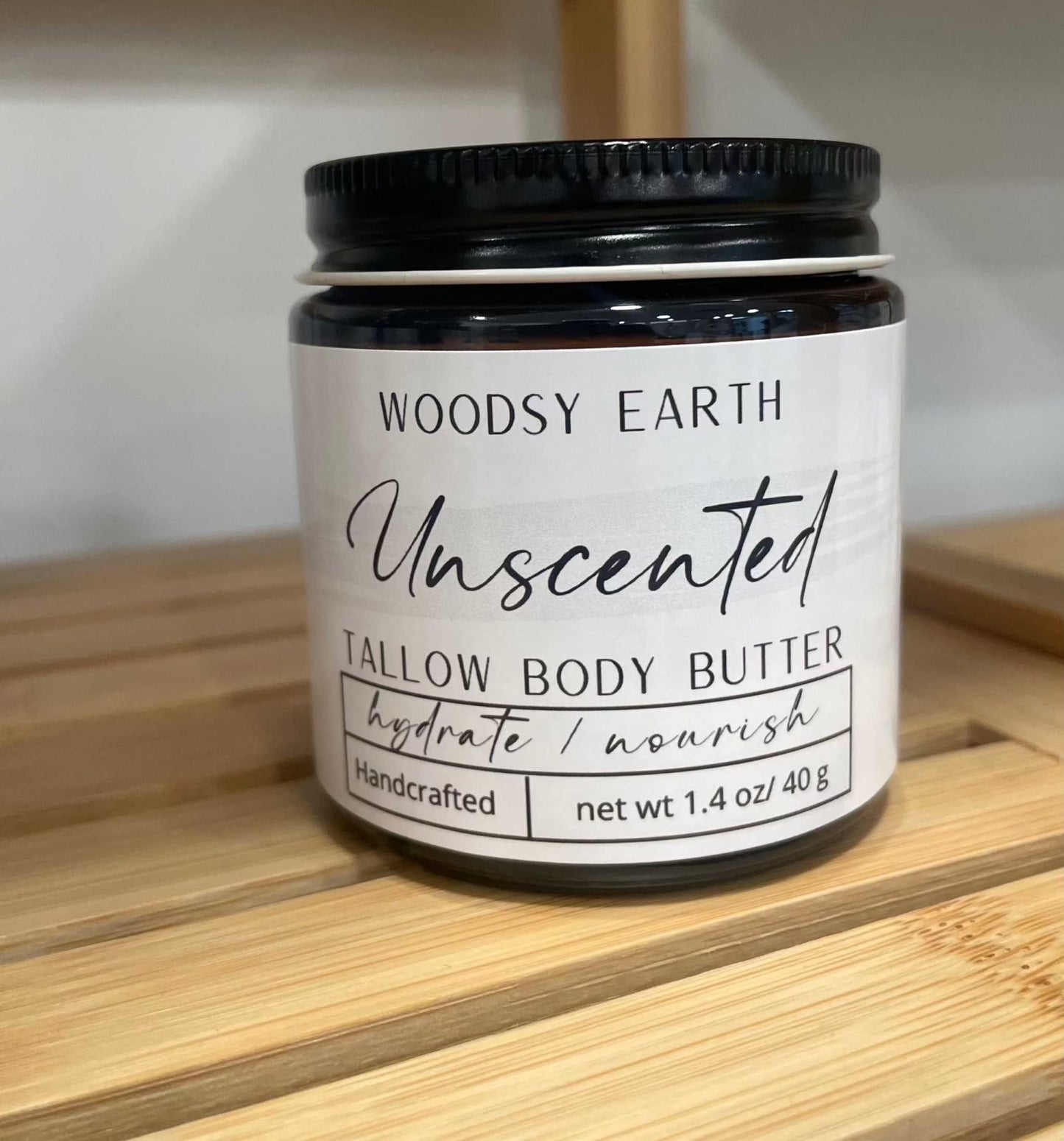 Woodsy Earth Unscented Tallow Body Butter in 4 oz amber glass jar with black lid. Handcrafted moisturizer for sensitive skin.