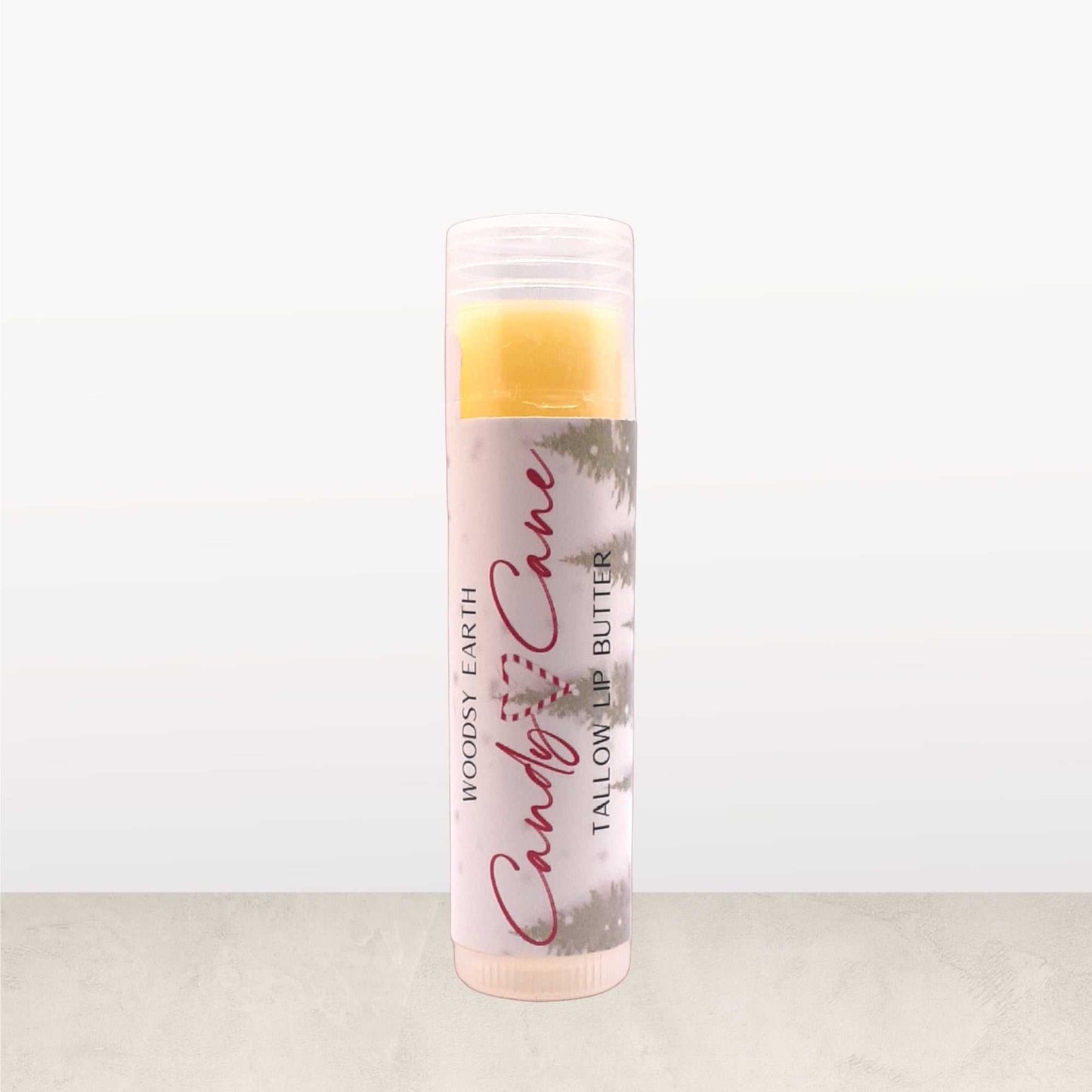 Candy Cane Tallow Lip Butter in clear tube, made with peppermint, spearmint, and vanilla oils for a festive holiday lip balm.