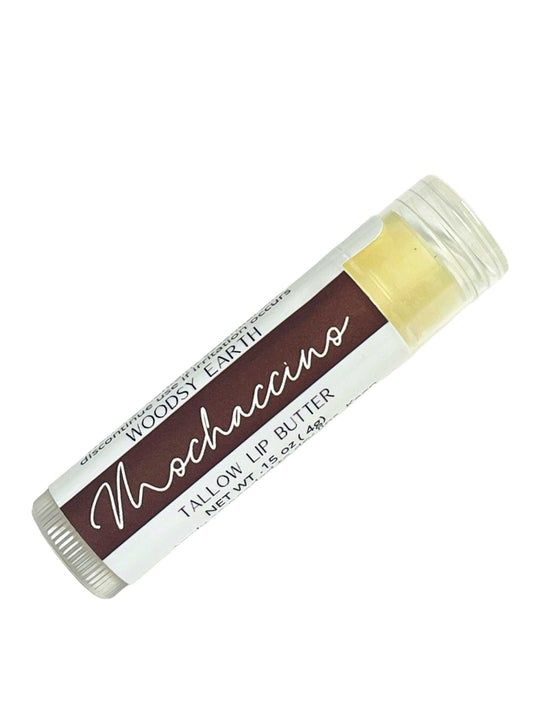 Woodsy Earth Mochaccino Tallow Lip Balm in clear .15 oz tube with brown label, natural coffee-inspired moisturizing lip butter.